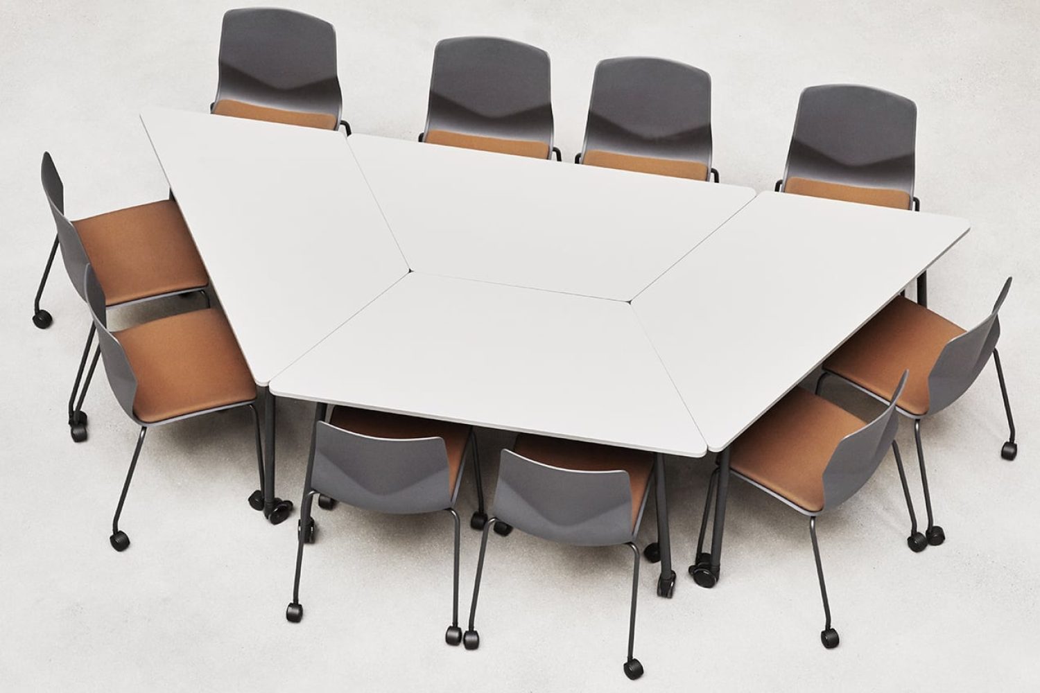 A conference table with office desk chairs around it.