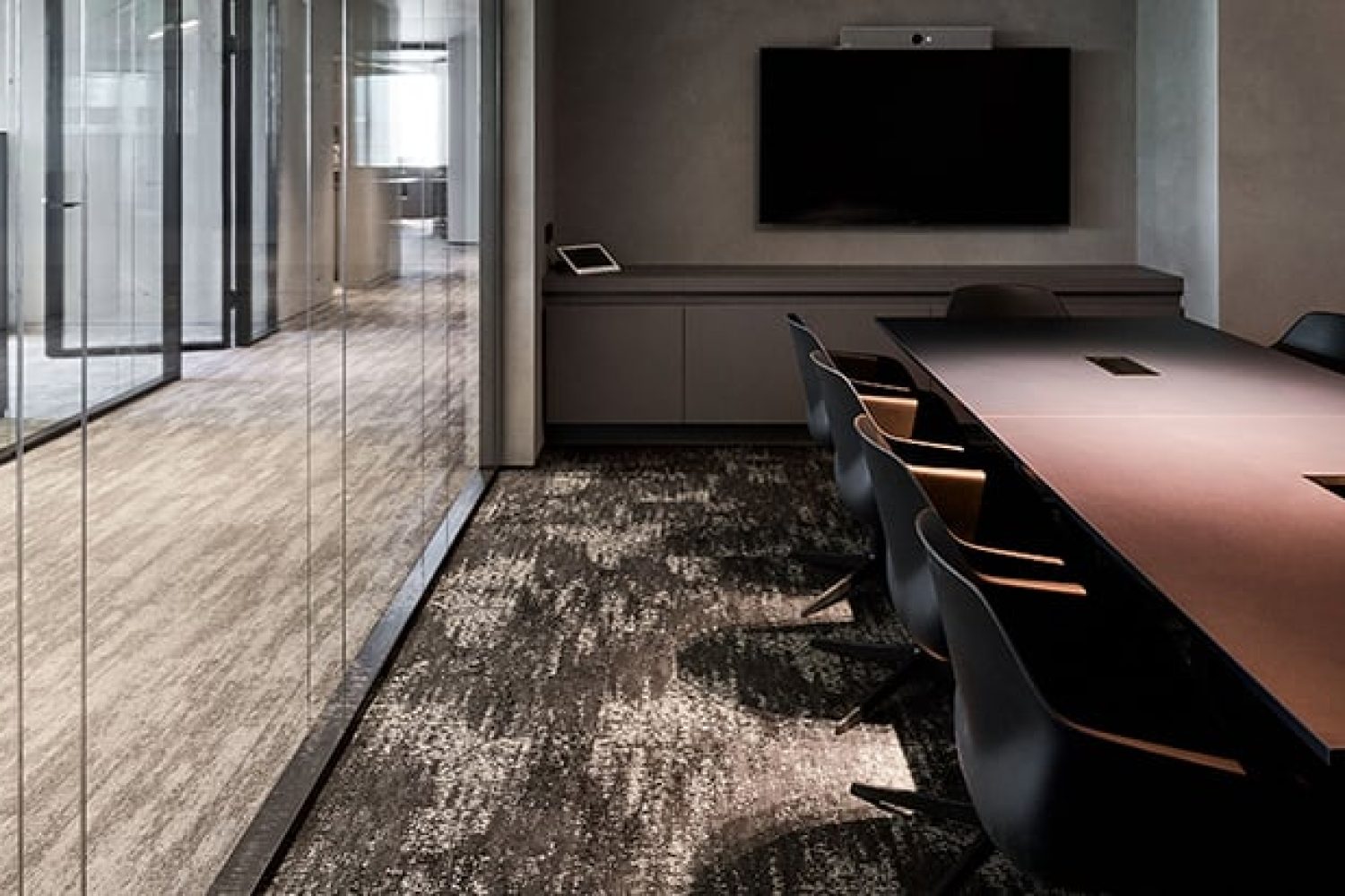 A conference room with a glass wall and chairs.