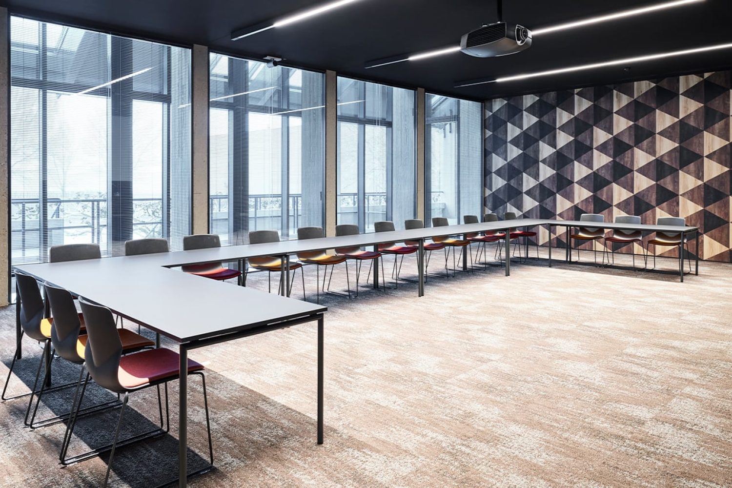 A conference room with a long table and chairs.