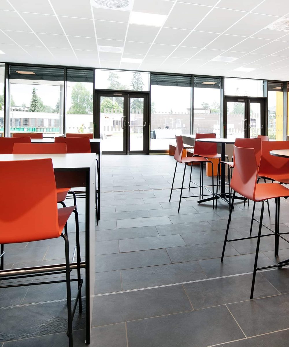 A room with standing height tables and chairs.