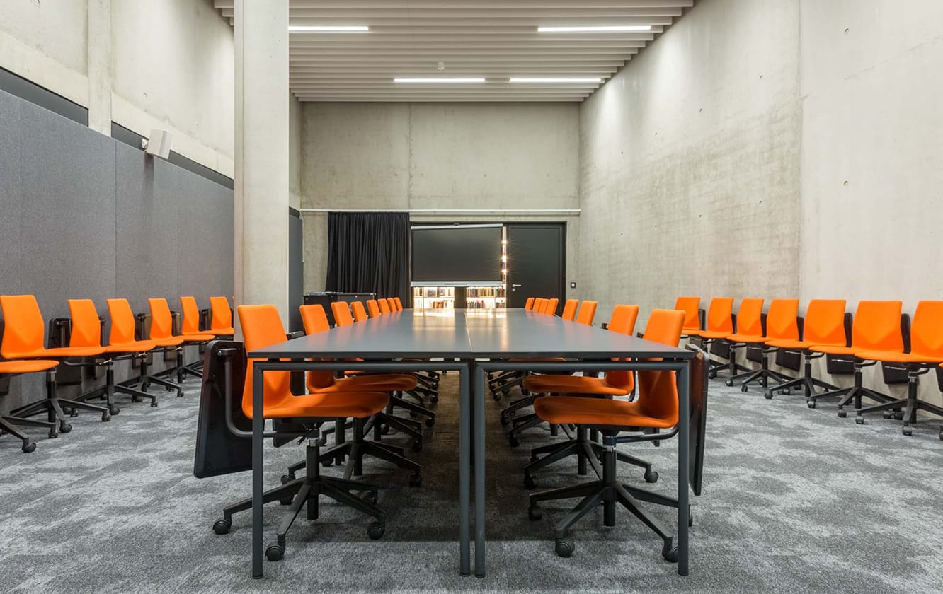 A conference table and office desk chairs in a conference room.