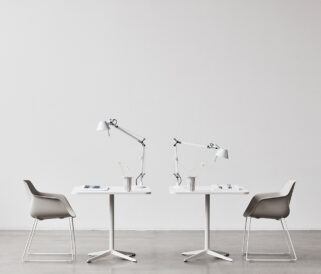 Two chairs and a table in a room with white walls.