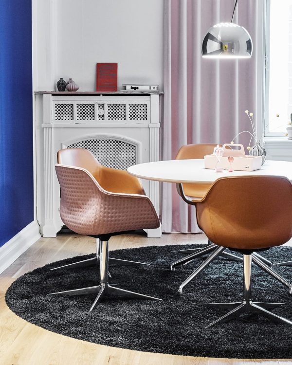 A round table and chairs in a room with blue walls.