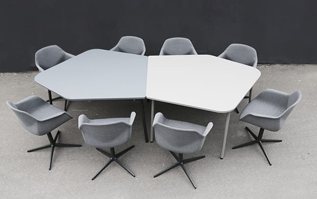 Four grey lounge chairs for offices and a table in a circle.
