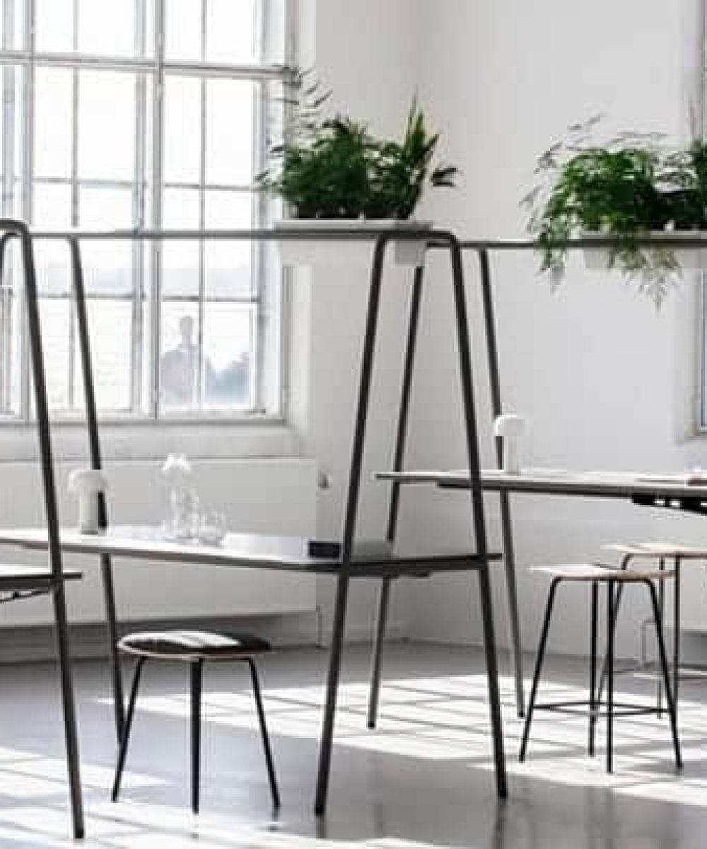 Community tables with stools and chairs in an office.