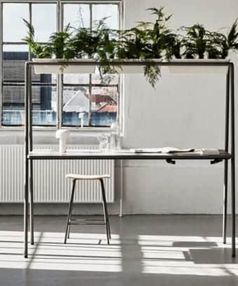 Community tables with stools and chairs in an office.