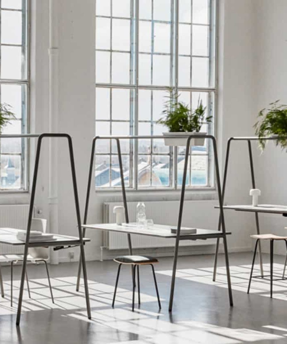 Community tables with stools and chairs in an office.