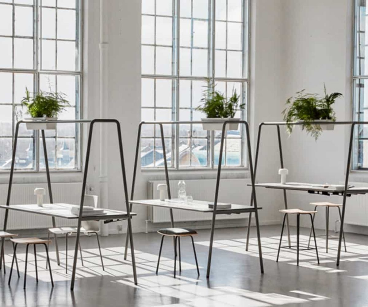 Community tables with stools and chairs in an office.