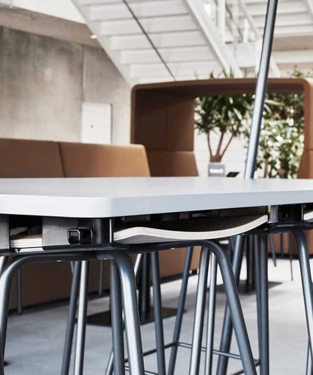 A table with stools and chairs in an office.