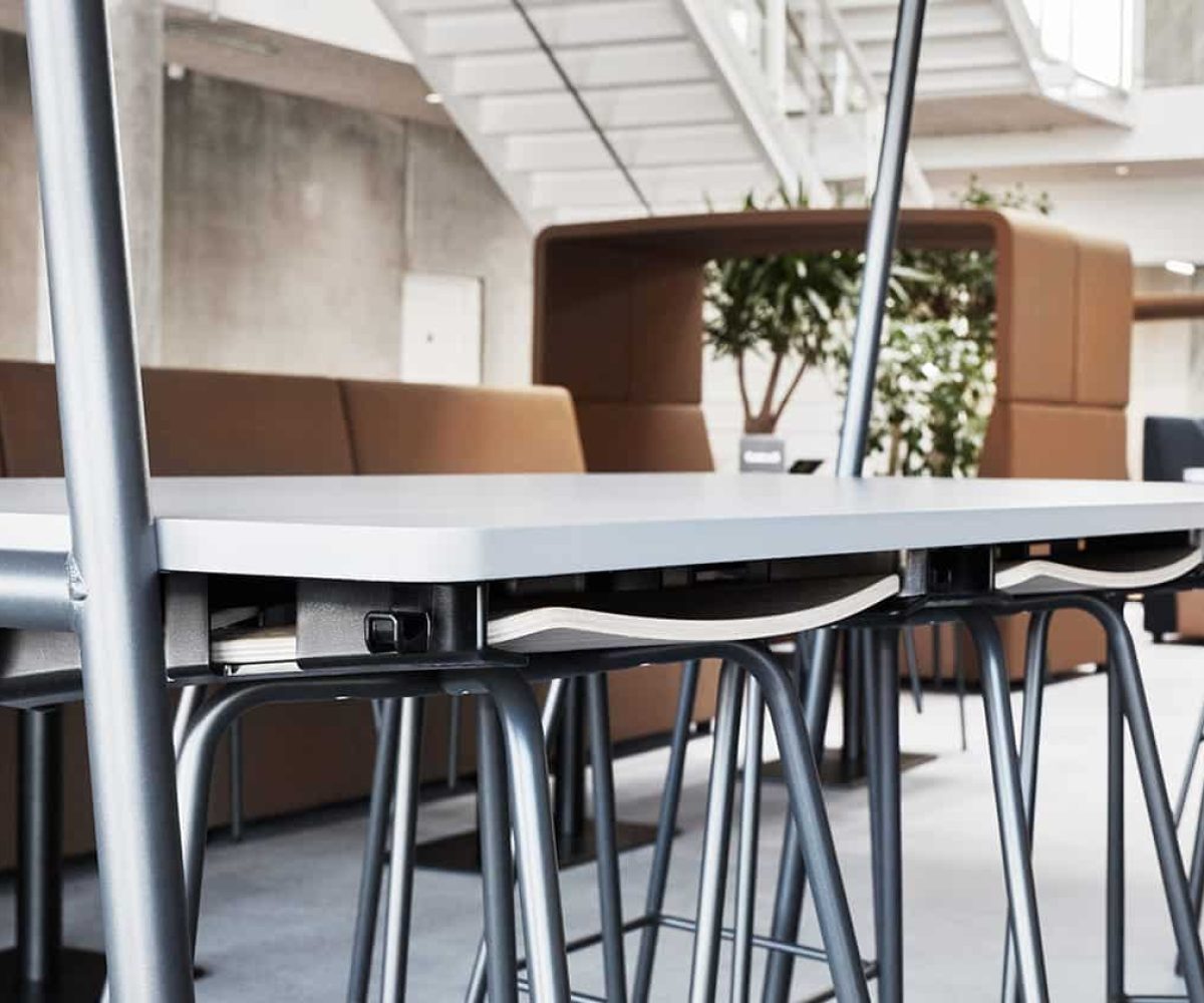 A table with stools and chairs in an office.