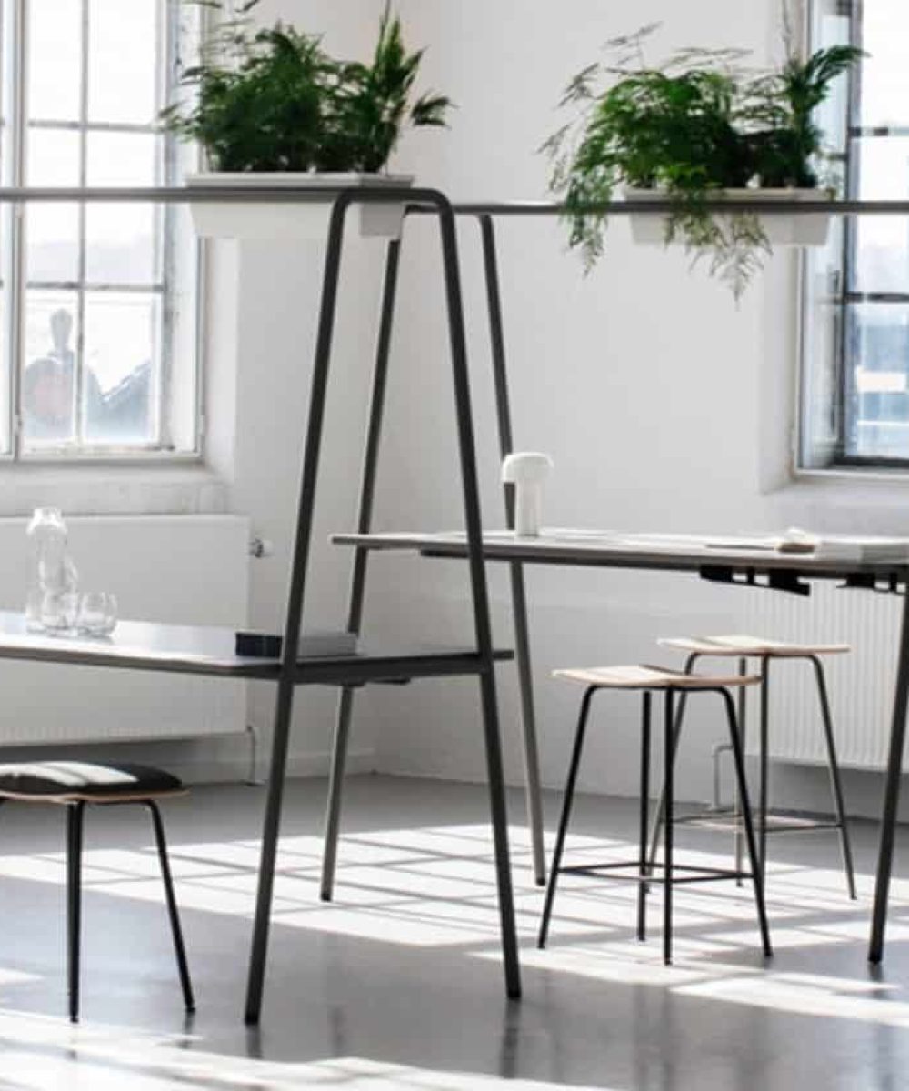 Community tables with stools and chairs in an office.