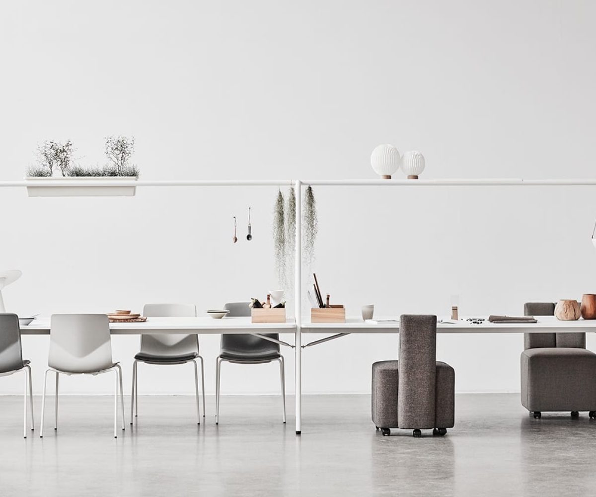 A group of chairs and tables in a white room.