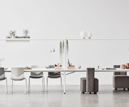 A group of chairs and tables in a white room.