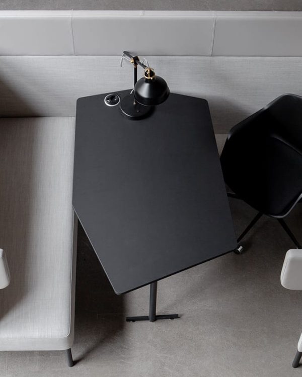 A small office work booth with a table and chairs in the corner.