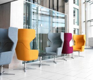 Five lounge chairs for offices and a table in a lobby.
