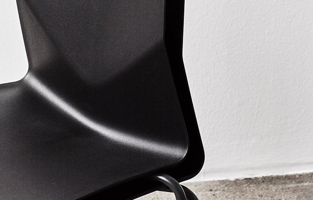 A detail of a black chair seat