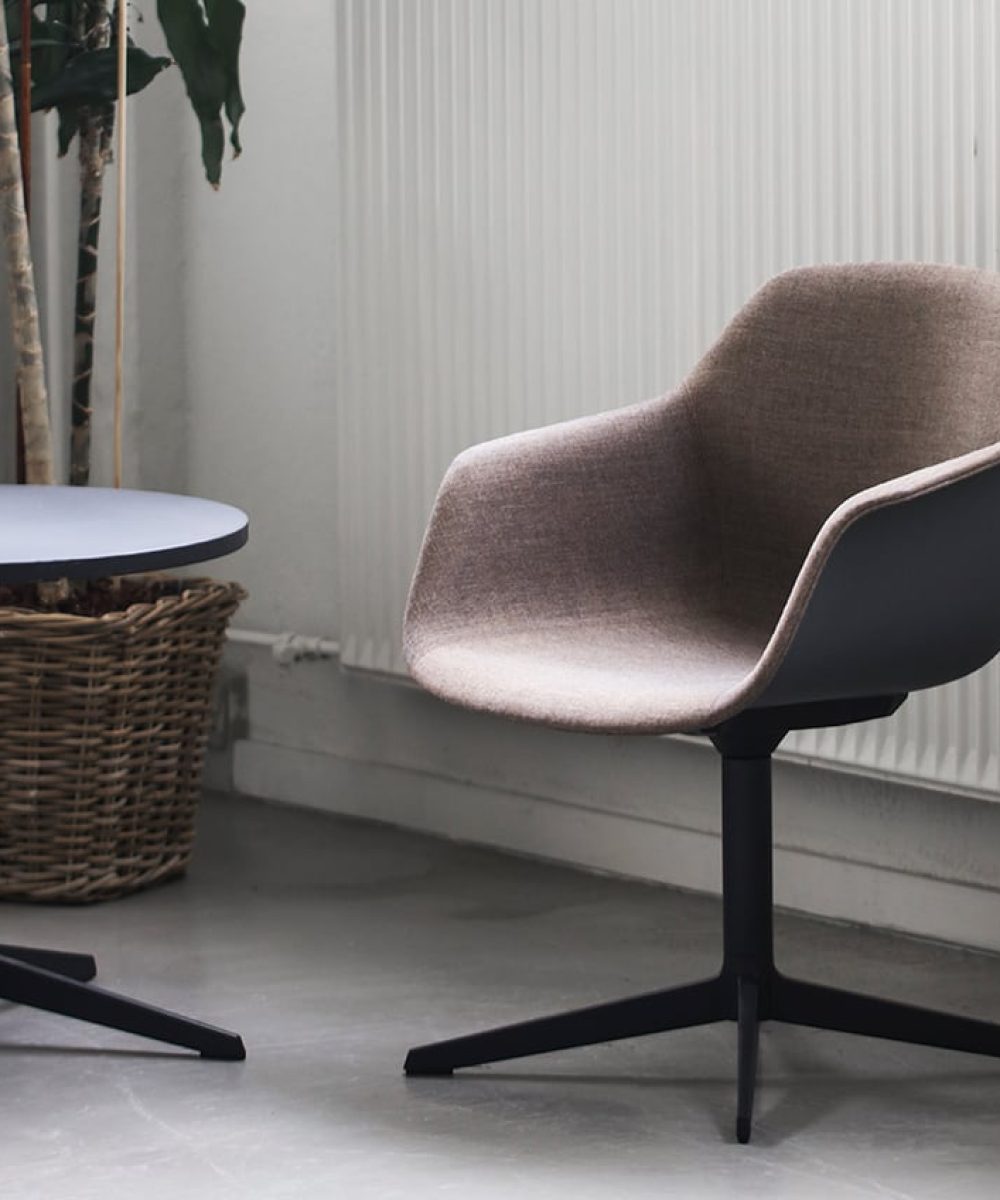 Two chairs and a table in a room with a potted plant.