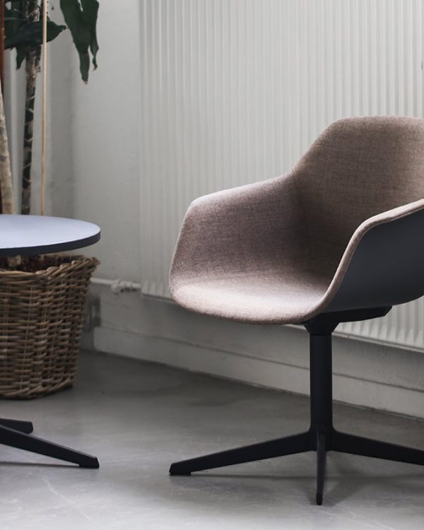 Two chairs and a table in a room with a potted plant.