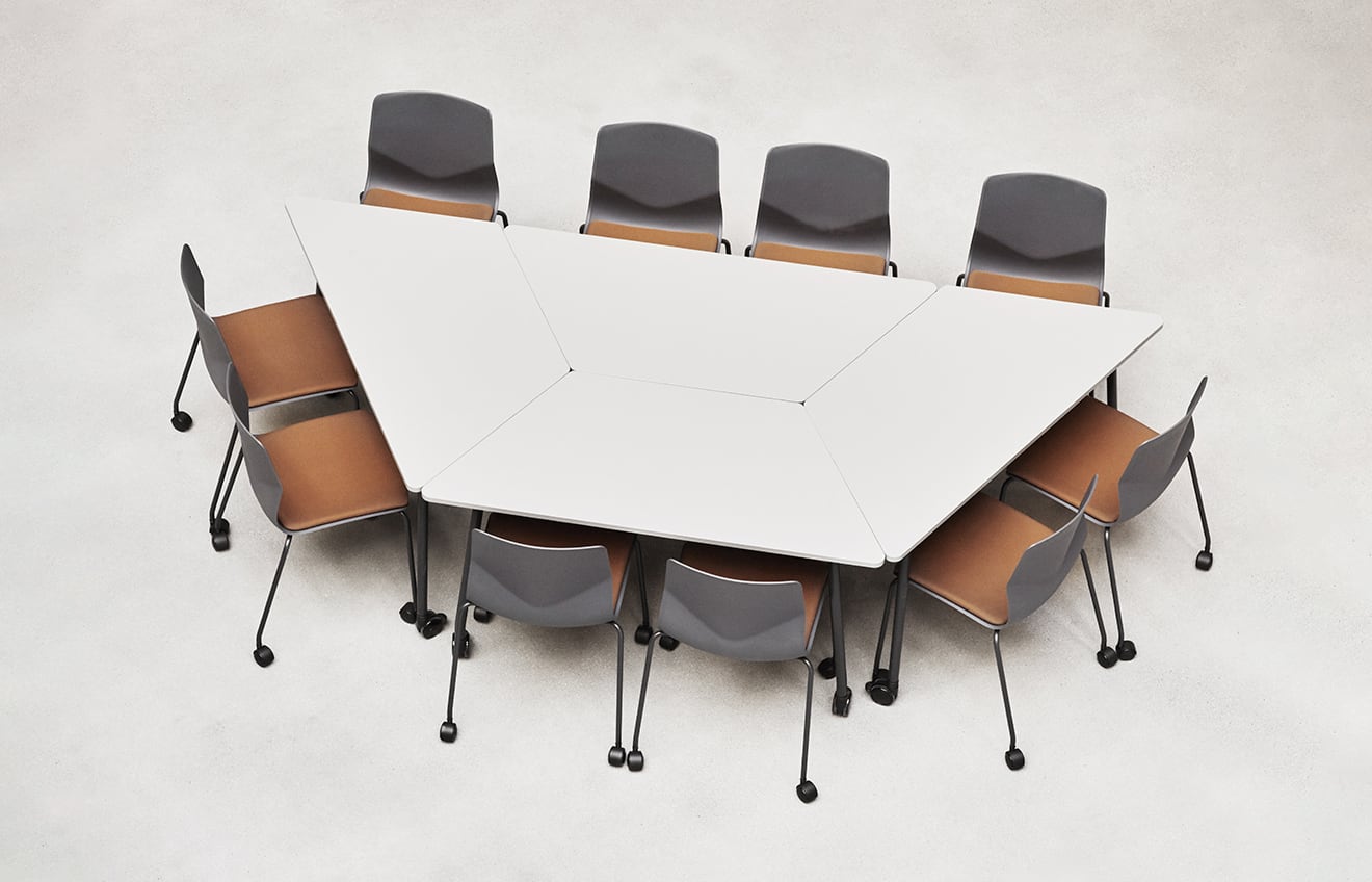 A white table with chairs arranged in a triangle.