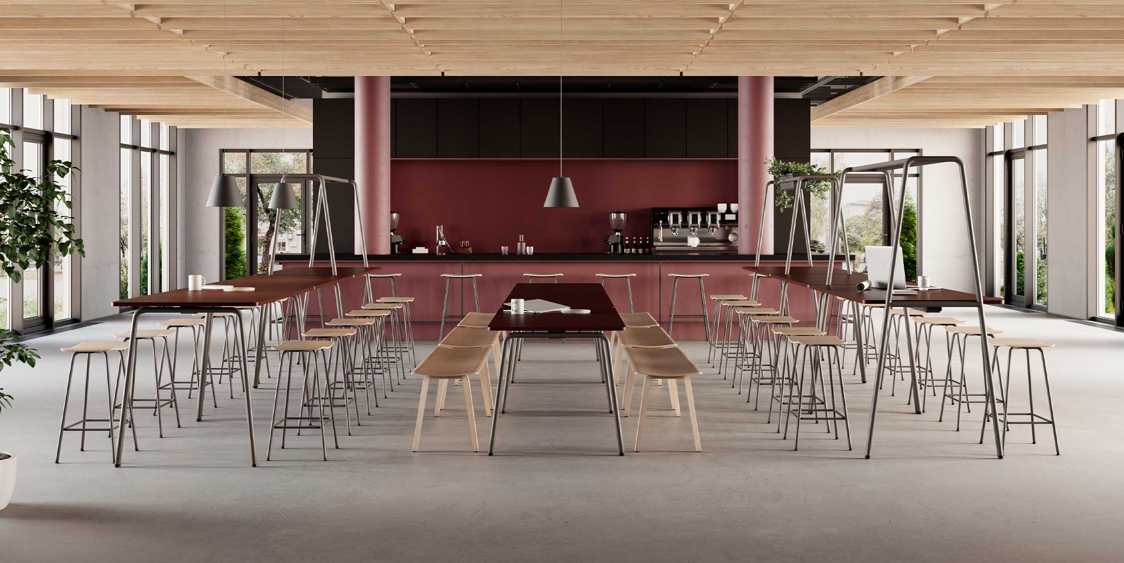 Canteen furniture in a dining room with a long table, community tables and chairs.