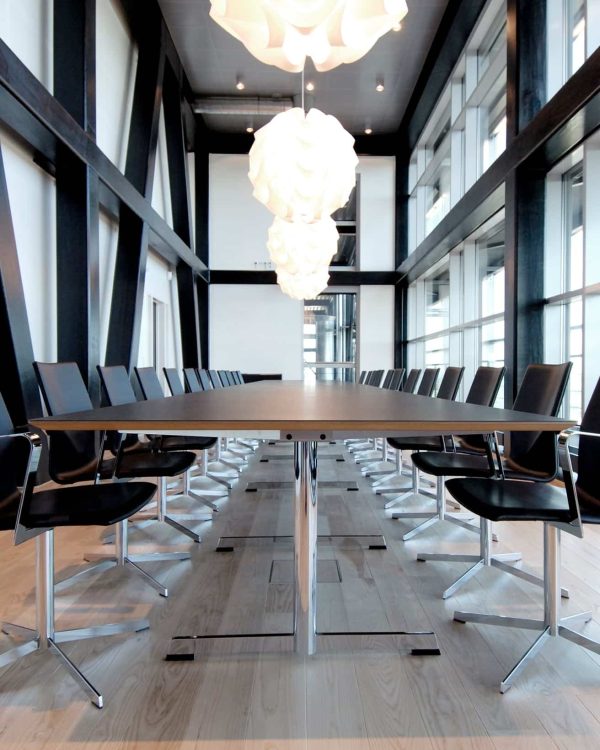 A conference room with a table and chairs.