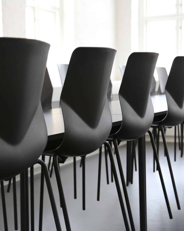 A row of black chairs in a conference room.