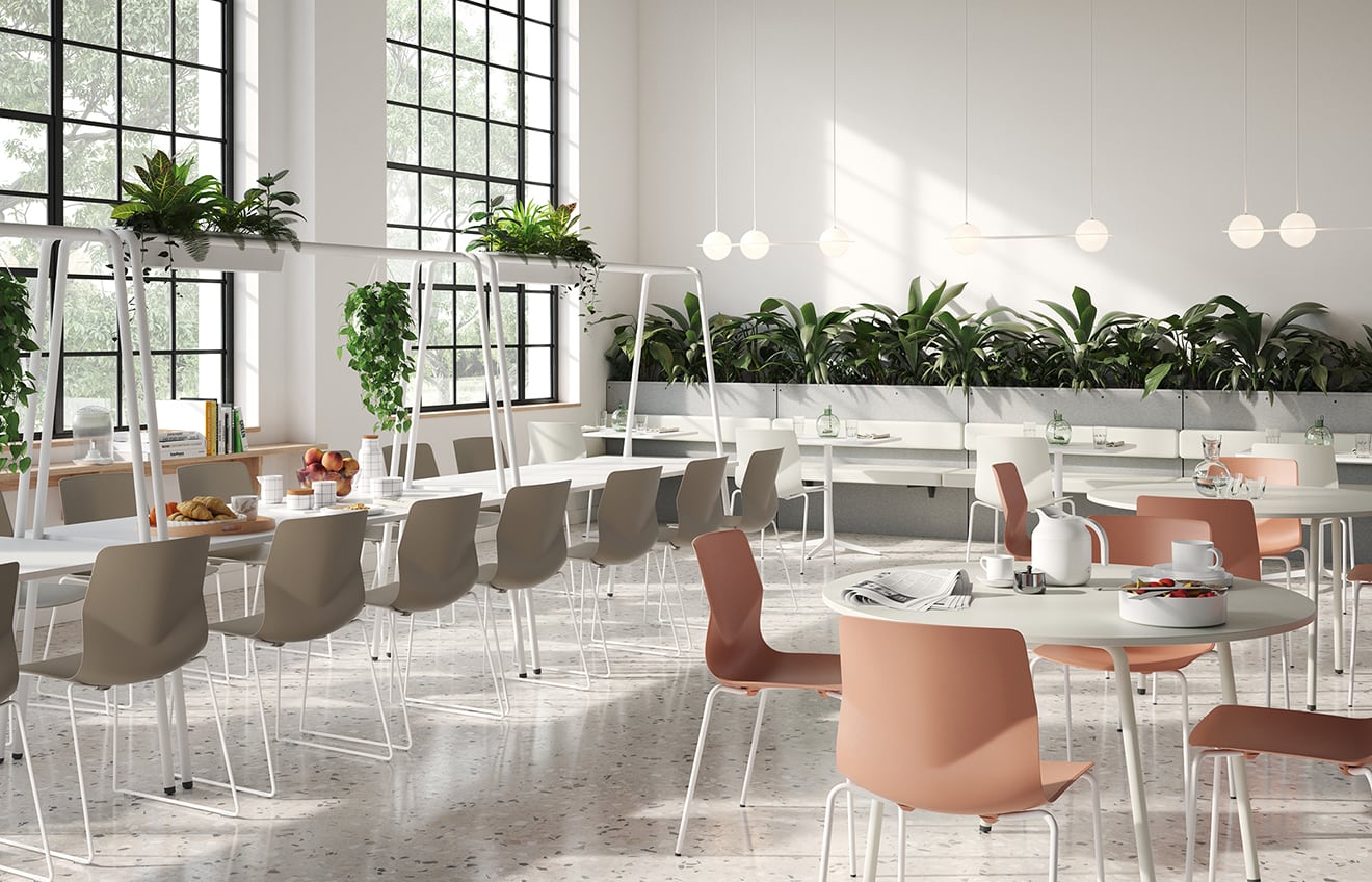 A dining room with canteen furniture with community tables and chairs.