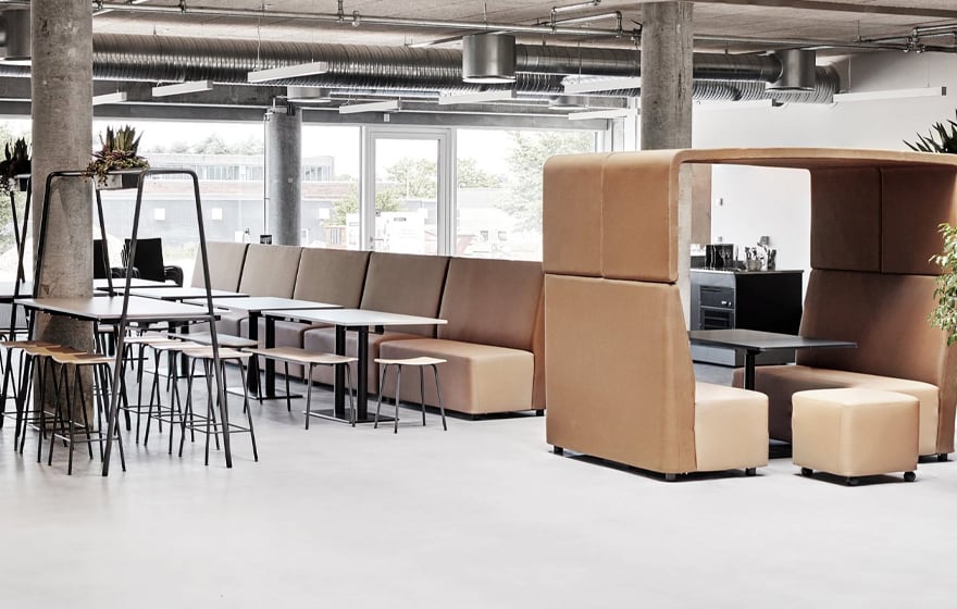 An office with office desk chairs, designer office tables, and stools and office work booths