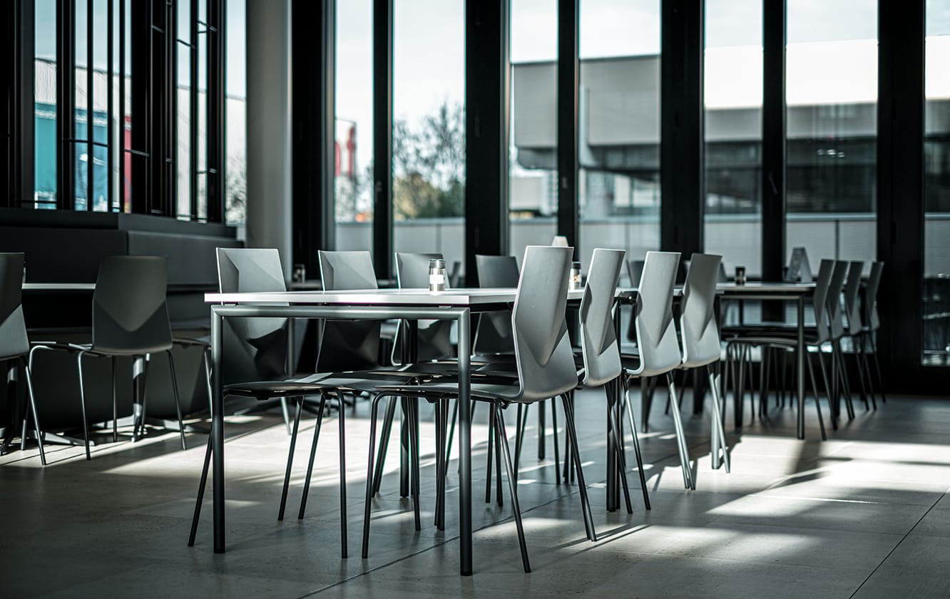A canteen with canteen furniture and black walls.
