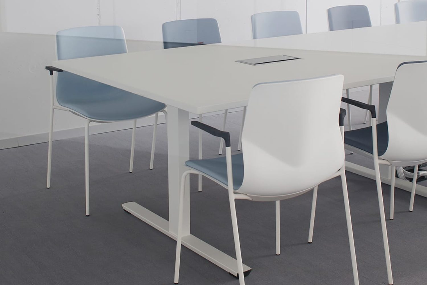 A group of office desk chairs and office tables in a lecture hall