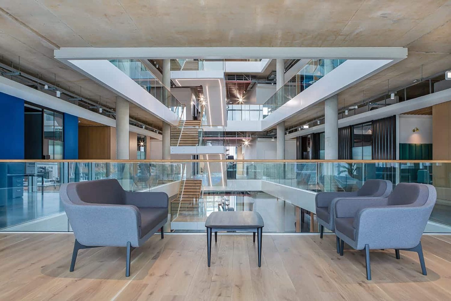 A modern office with a staircase and office sofas.