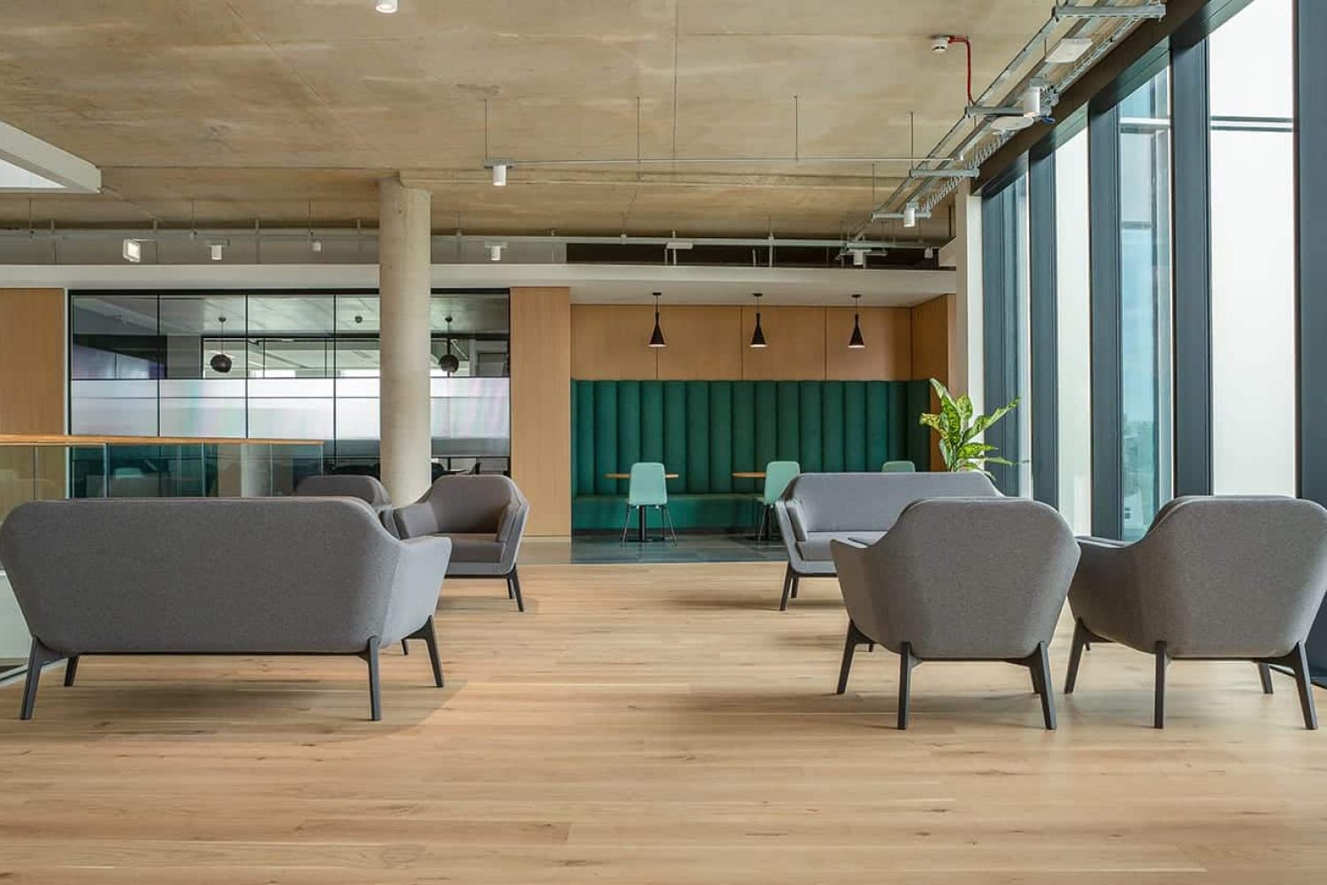 A modern office with a staircase and office sofas.