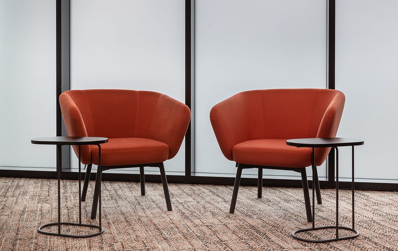 Two lounge chairs for offices in an office with two office coffee tables