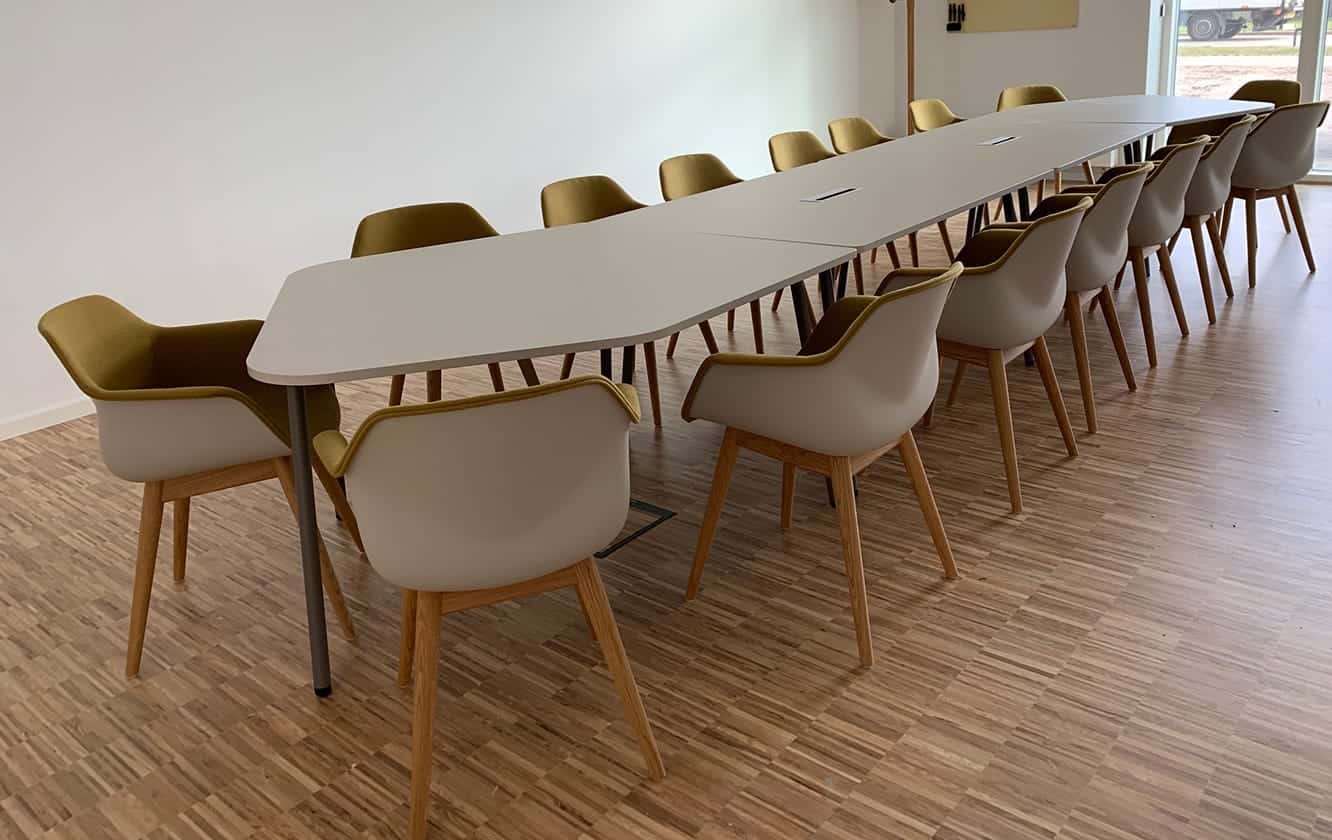 A room with a long table and chairs.
