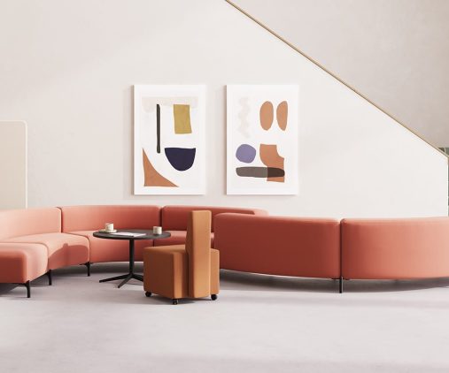 A reception area in an office with modular seating office sofas, chairs and a coffee table.