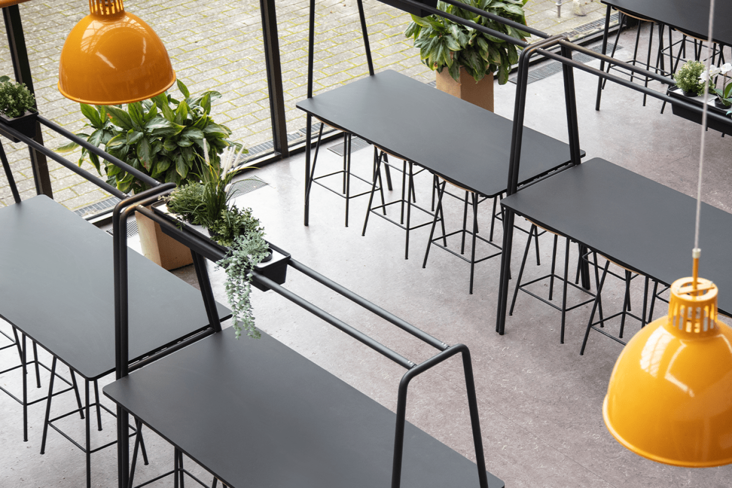 The interior of a canteen with canteen furniture, community tables and chairs.