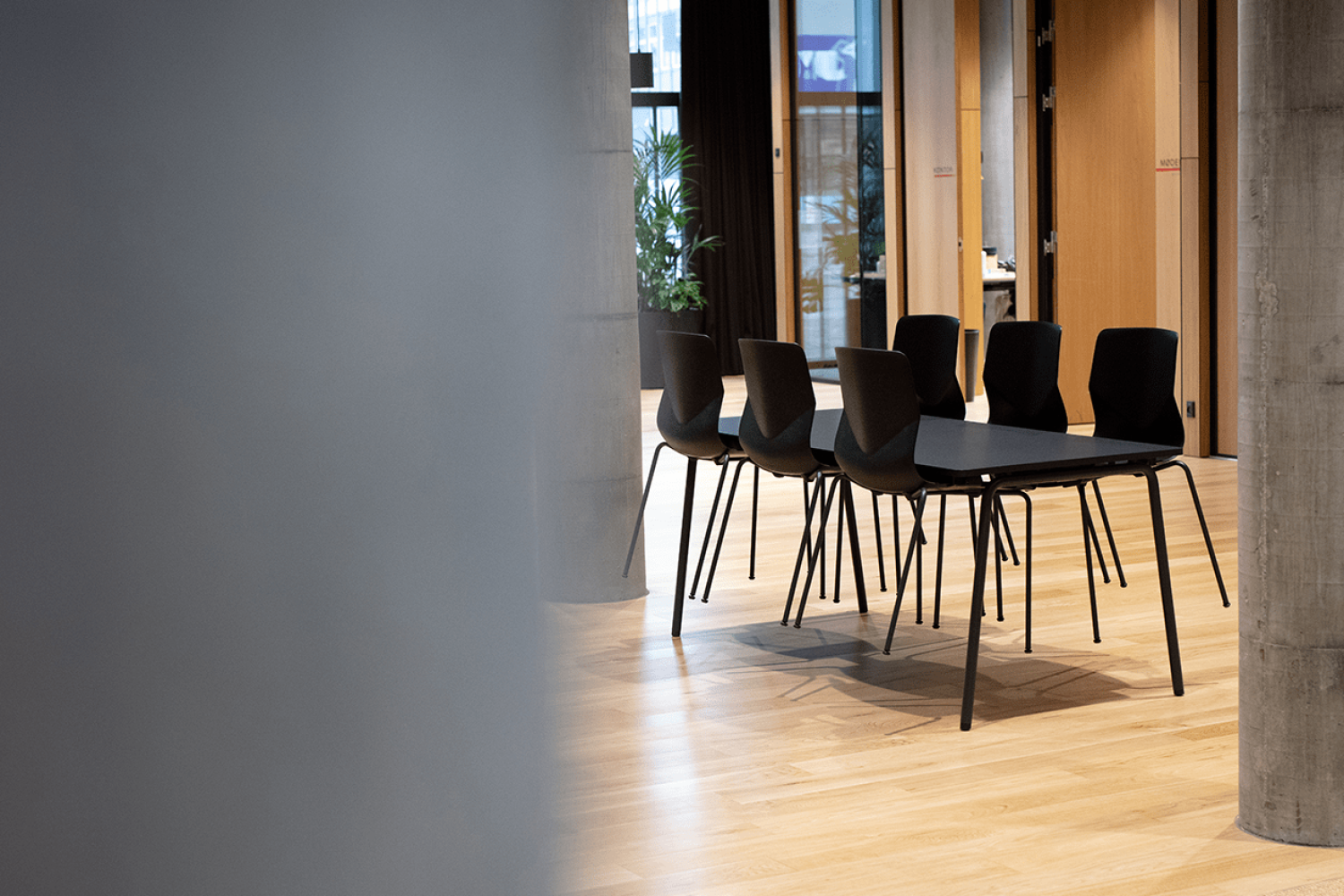 Canteen furniture including black table and chairs in a dining room.