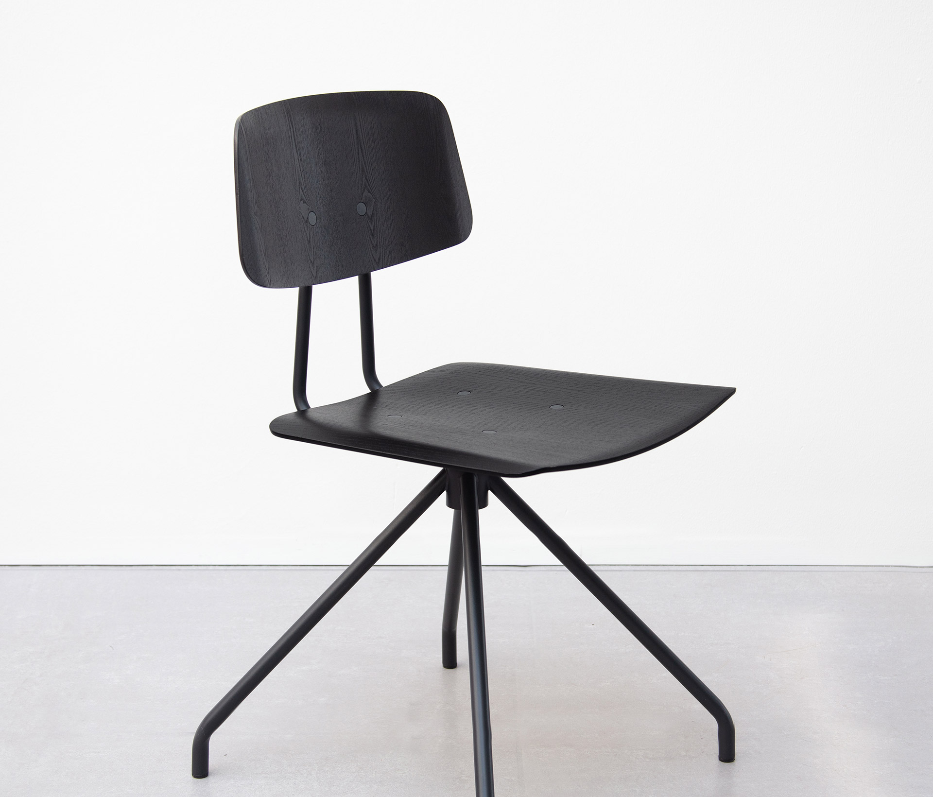 A black wooden office chair without arms on a black metal base.