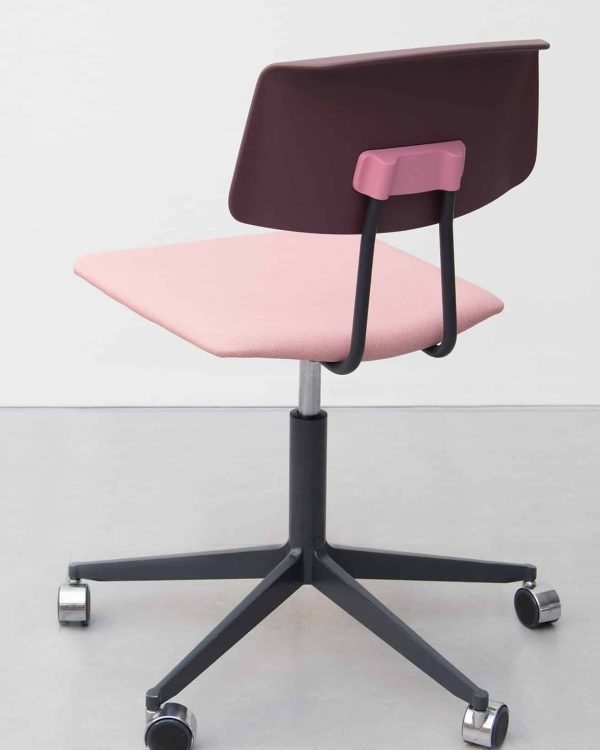 A pink office chair with a black seat and wheels.