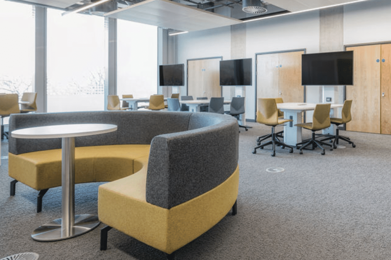 A conference room with Ocee and Four Design office furniture including yellow chairs and tables at the University of Sheffield.