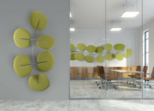 A modern office with green office acoustic solutions that look like leaves on the wall.
