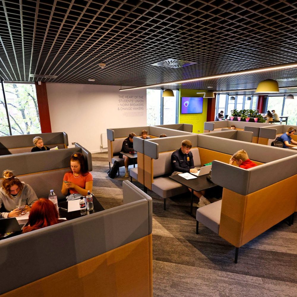 A group of people sitting in a conference room.