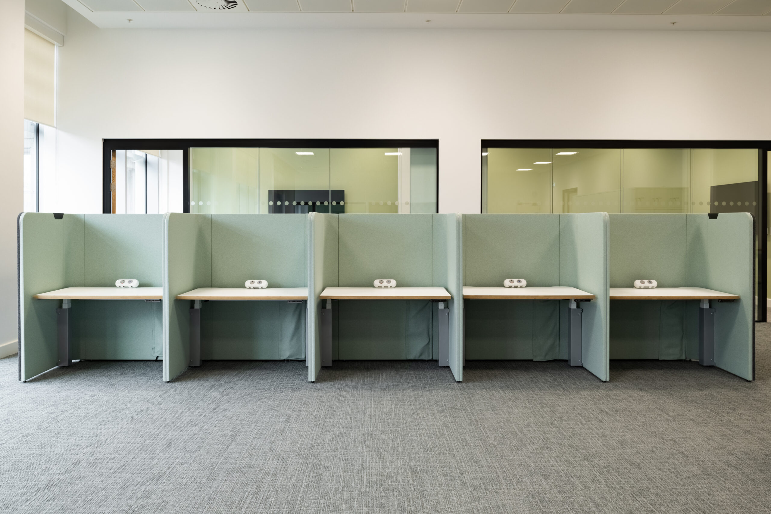 A row of green Ocee and Four work booths and cubicles in an office in Crawley Council Town Hall.