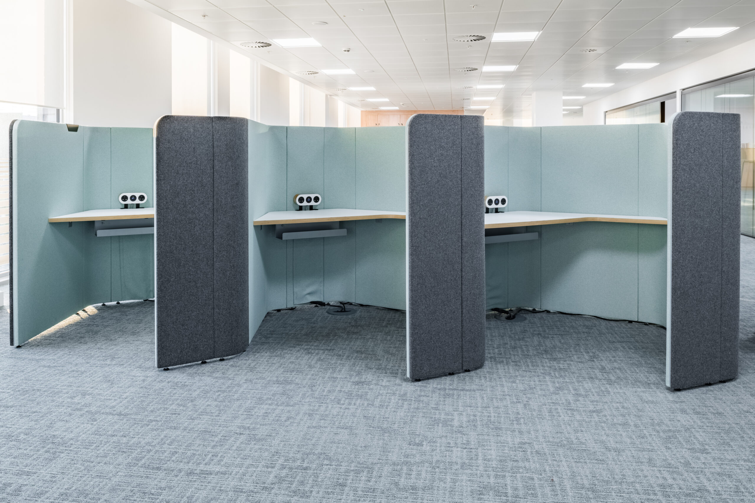 A group of Ocee and Four Design office work booths and office cubicles in an open office at Crawley Council Town Hall.