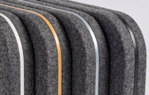 A row of black and grey felt Den partitians for office spaces with a gold stripe.