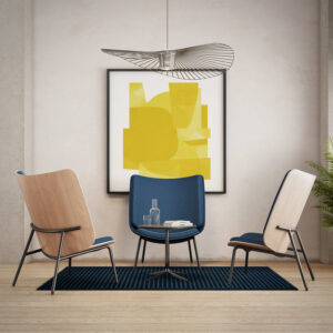 Three chairs in a room with a yellow painting.