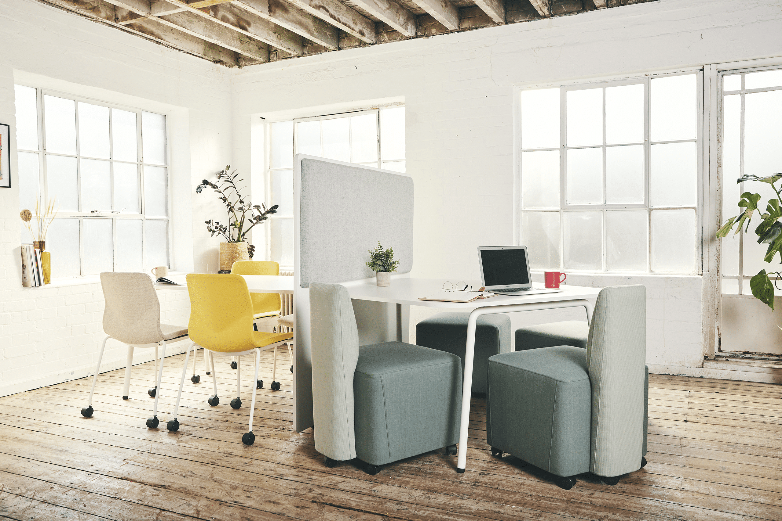 An office with FourReal office seating and RoomInRoom office tables and windows.