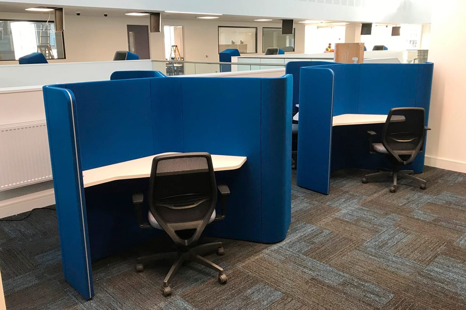 Two Ocee and Four Design blue cubicles in an office with desks and chairs at Coventry University