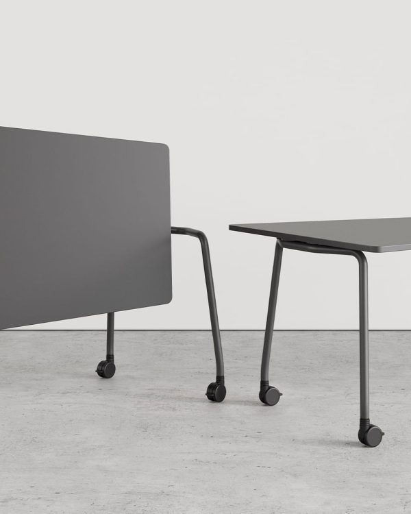 Two grey tables on wheels next to each other.