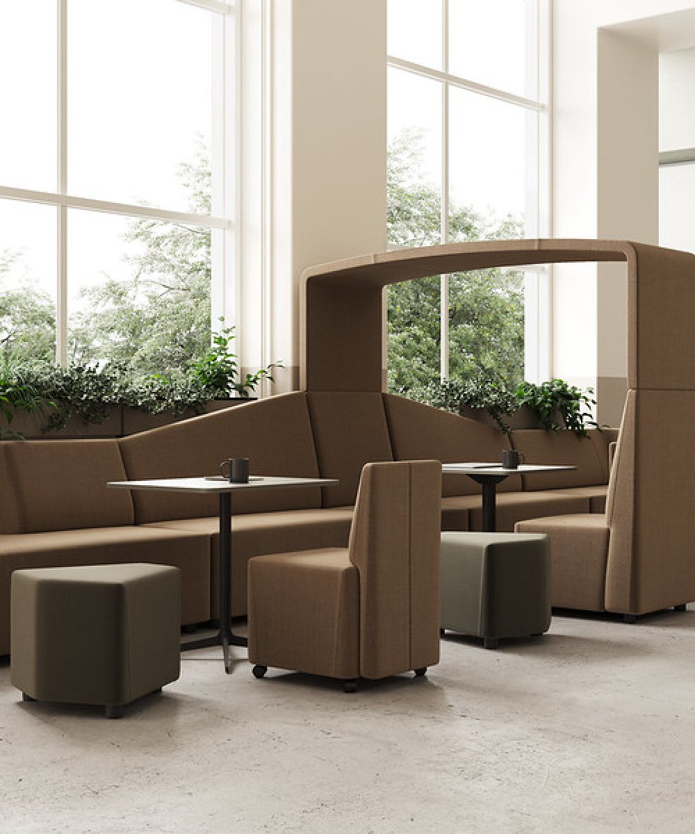 A lounge area with FourLikes office furniture including couches and chairs in a modern office.